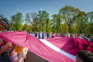 Vibrant Crowd Celebrating in Riga, Latvia A Festival of National Pride and Unity photo