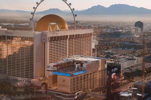 Golden Hour View of Las Vegas Strip with High Roller and Mountains photo