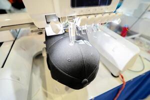 Close up picture workspace of embroidery machine stitching a logo photo