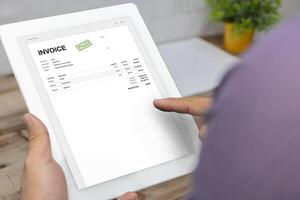 Close-up of businessman's hands working on invoice photo