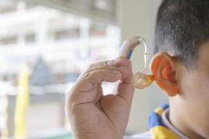 An Asian student, she has to use a hearing aid. photo