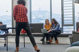 Business colleagues take a break from work to enjoy a game of table tennis, fostering teamwork and camaraderie in the workplace photo