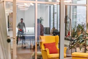 Business colleagues take a break from work to enjoy a game of table tennis, fostering teamwork and camaraderie in the workplace photo