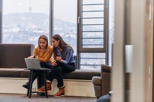 Business Colleagues Reviewing Work on Laptop During Break photo