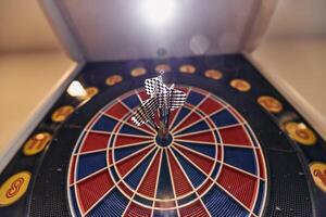 Dart board has dart arrow hitting of a shooting target for business targeting and good success photo