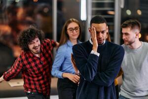 A group of young business people have fun playing interesting games while taking a break from work in a modern office. Selective focus photo