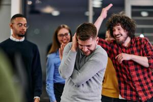 A group of young business people have fun playing interesting games while taking a break from work in a modern office. Selective focus photo
