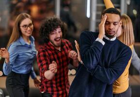 A group of young business people have fun playing interesting games while taking a break from work in a modern office. Selective focus photo