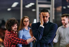 A group of young business people have fun playing interesting games while taking a break from work in a modern office. Selective focus photo