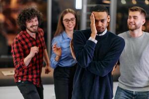 A group of young business people have fun playing interesting games while taking a break from work in a modern office. Selective focus photo