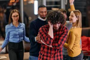 A group of young business people have fun playing interesting games while taking a break from work in a modern office. Selective focus photo