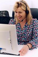 Friendly Call Center Agent Answering Incoming Calls with Headset Providing Remote Customer Service. photo