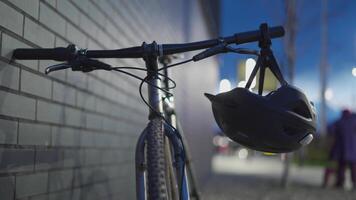 Helmet with red signal lights on bike handlebars in the city at night. The topic is cyclist safety on the road in the dark. Bicycle back light on a bicycle helmet. Flashlight and back red light video