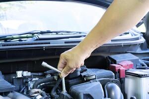 Automotive mechanic working in garage. Repair service. Mechanic working on a diesel engine, close up. Technician hands of car mechanic in doing auto repair service and maintenance worker repairing photo