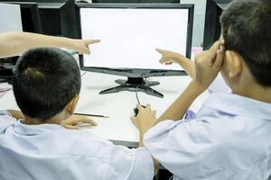 Teamwork concept. Students are learning in Technology by working with computers, photo
