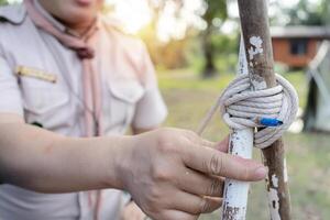 The Scout director is teaching how to tie a wood using knot methods. photo