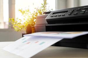 The printer is fully functional,Located on the desk. photo