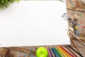 A desk with many stationery items placed,Large blank paper to put different content messages. photo