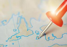 Travel concept. Red pins are embroidered on the map. photo