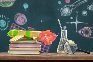 Many books are placed on the table, Paper rocket. And a magnifying glass, Beaker. photo