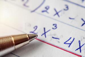 Math problem solving,Must use computational skills. The pen is placed on paper. photo