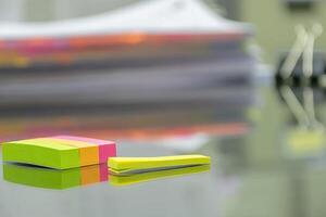 Many documents are placed on the desk.Used post-it as Alert tools for editing. photo