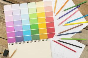 Various shades used in the design, creation, work. Are placed on a desk with colored pencils. photo