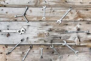 diverse wrench tools on wooden table in garage. and blank copy space photo