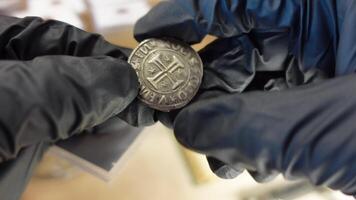 Collector examining Old Coin video