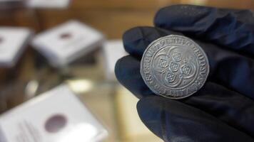 Collector examining Old Coin video
