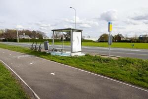 demolished bus stop in besides a road photo