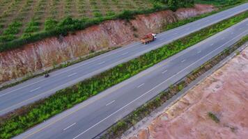 Aerial view of countryside asphalt road with car and green forest. Drive on the road between green forests. video