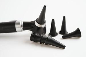 Otoscope isolated on white background for otolaryngologist or ENT physician doctor examining senior patient ear, hearing loss problem. photo