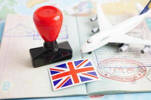 Bangkok, Thailand December 10, 2023 British visa and passport with airplane and flag on white background with copy space. photo