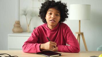 Happy african american teen girl blogger smiling face talking to webcam recording vlog. Social media influencer woman streaming making call at home. Headshot portrait selfie webcamera view video