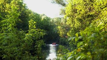 Tourists are rafting on a peaceful river. View from afar. video