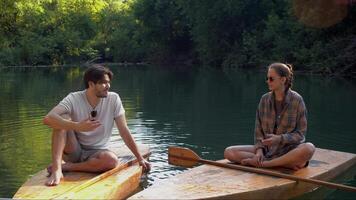 Couple in love, on rafts, smiling, chatting and laughing while rafting down the river. video