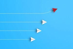 Group of white paper planes in one direction and one red paper plane pointing in different way on blue background. Business for new ideas creativity vector