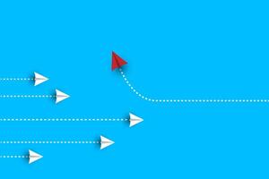 Group of white paper plane in one direction and one red paper plane pointing in different way on blue background. vector