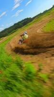 Dynamic FPV shot of a racer on a motocross bike on a track at high speed video