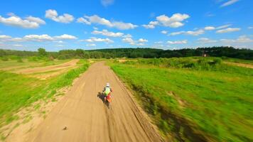 Dynamic FPV shot of a racer on a motocross bike on a track at high speed video