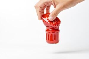 Hand holding jar of tomato sauce photo