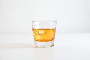 Single Glass of Whiskey with Ice on White Background photo