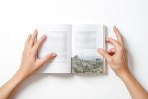 Hands holding open book with forest image photo