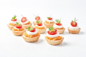 Appetizer Bites with Tomato and Cream Cheese on a White Background photo