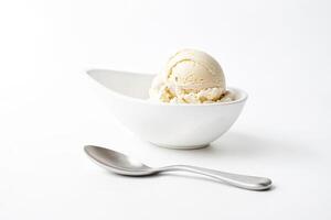 Close-up of a single scoop of vanilla ice cream in a white bowl with a spoon photo