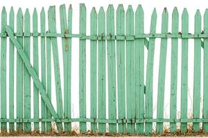 Old green wooden fence with broken boards photo