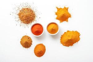 Spices in bowls and piles on white background photo