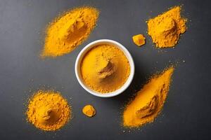 Turmeric Powder in Bowl and Heaps on Gray Background photo