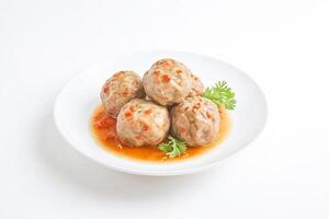 Close-up of Chinese Pork Meatballs with Sweet and Sour Sauce photo